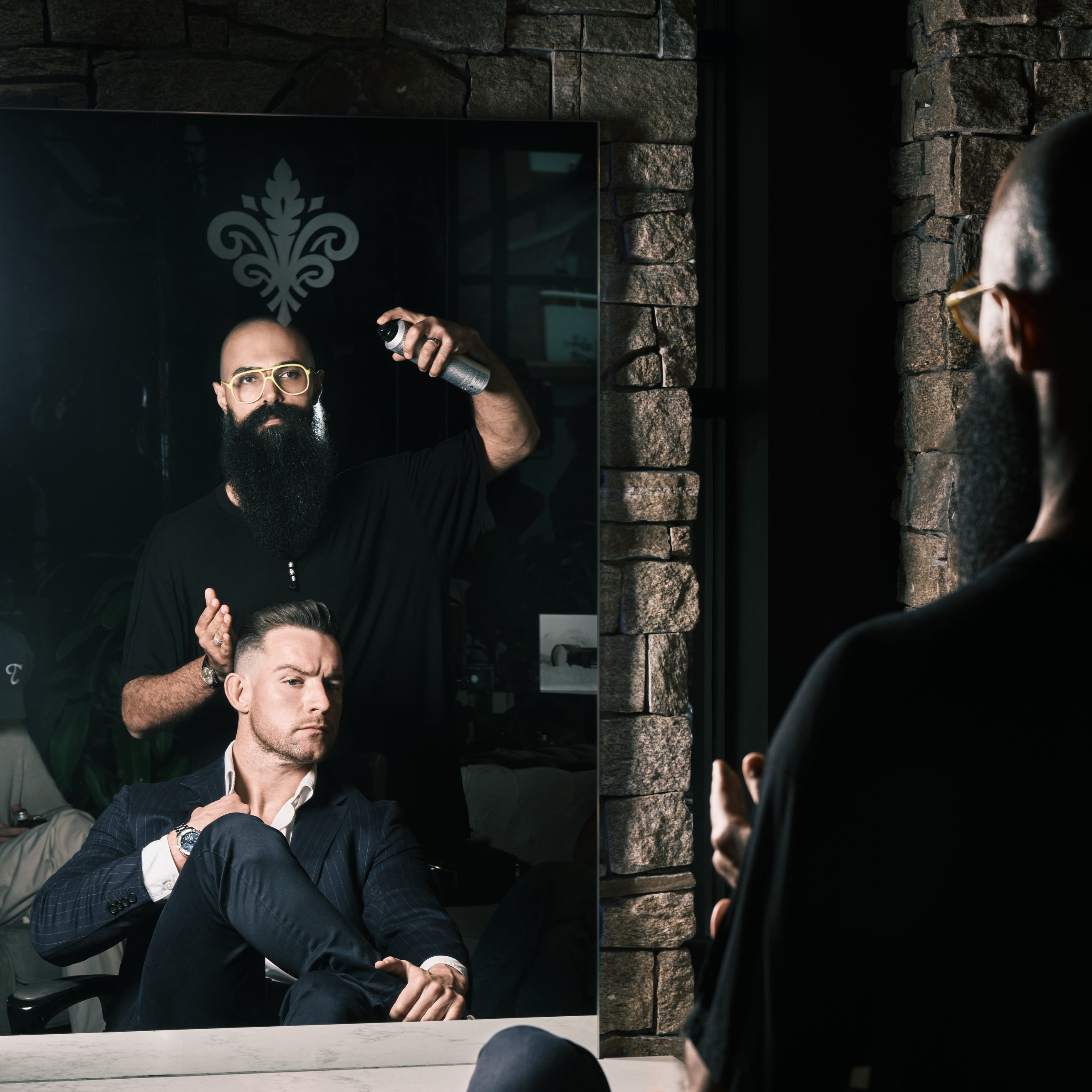 Barber spraying a client's hair at Langanis Studio